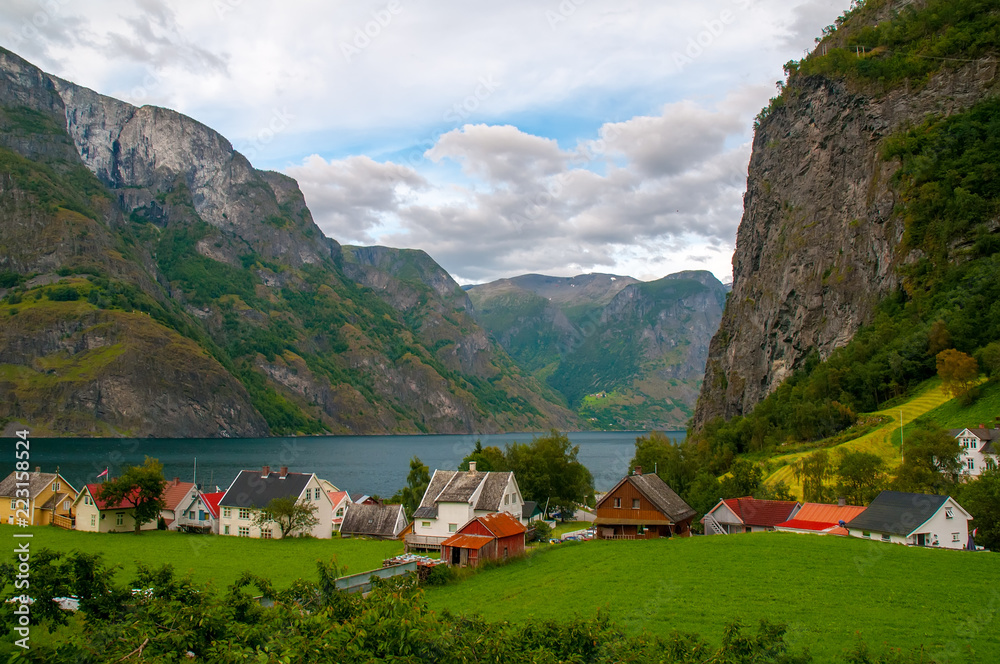Scenic view of the small village with colorful houses at the bank of the Aurland fjord in Undredal, Norway Scenic view of the small village with colorful houses at the bank of the Aurland fjord in Undredal, Norway