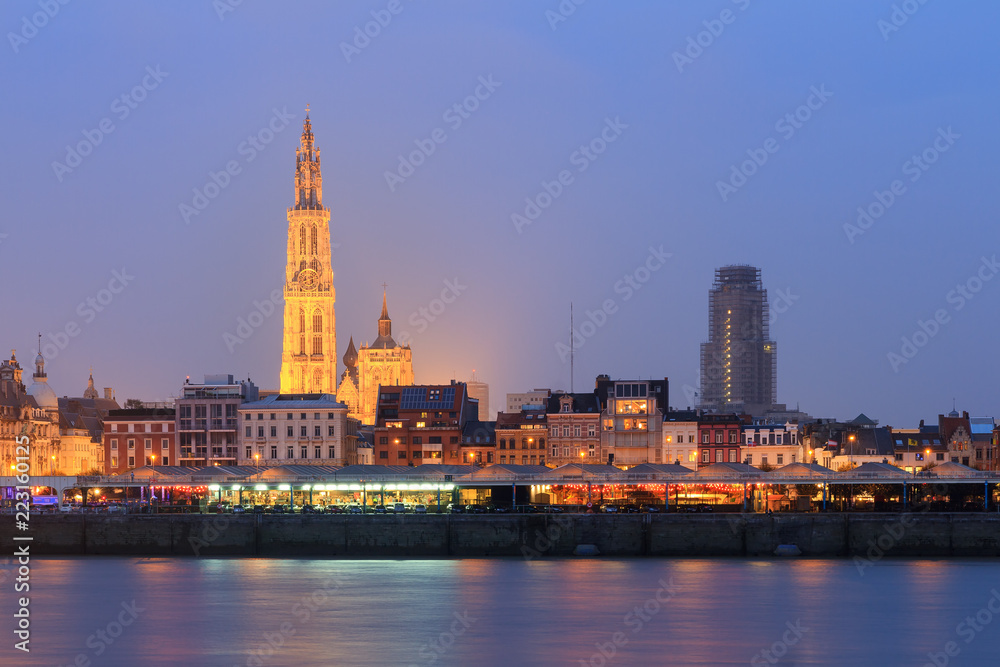 Fototapeta premium Beautiful cityscape of the skyline of Antwerp, Belgium, during the blue hour seen from the shore of the river Scheldt 
