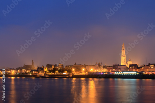 Beautiful cityscape of the skyline of Antwerp, Belgium, during the blue hour seen from the shore of the river Scheldt 