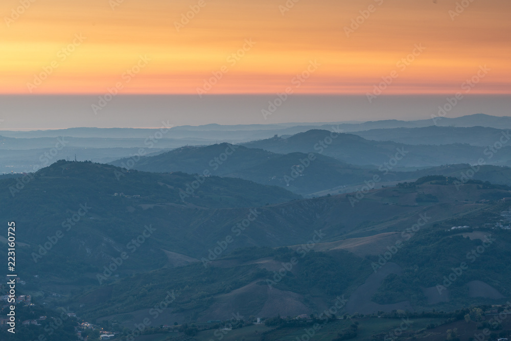Layered mountain ranges at sunrise