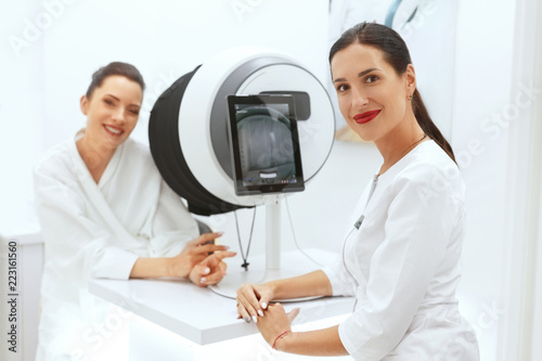 Face Skin Analyze. Cosmetologist Analyzing Woman Facial Skin