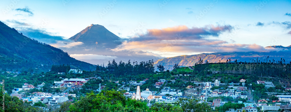 Panorama of town and volcano during sunrise in Andes of Ecuacor