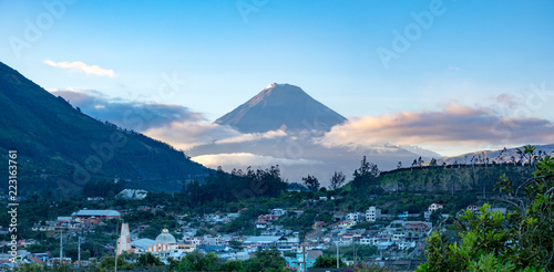Town and volcano during sunrise in Andes of Ecuacor photo