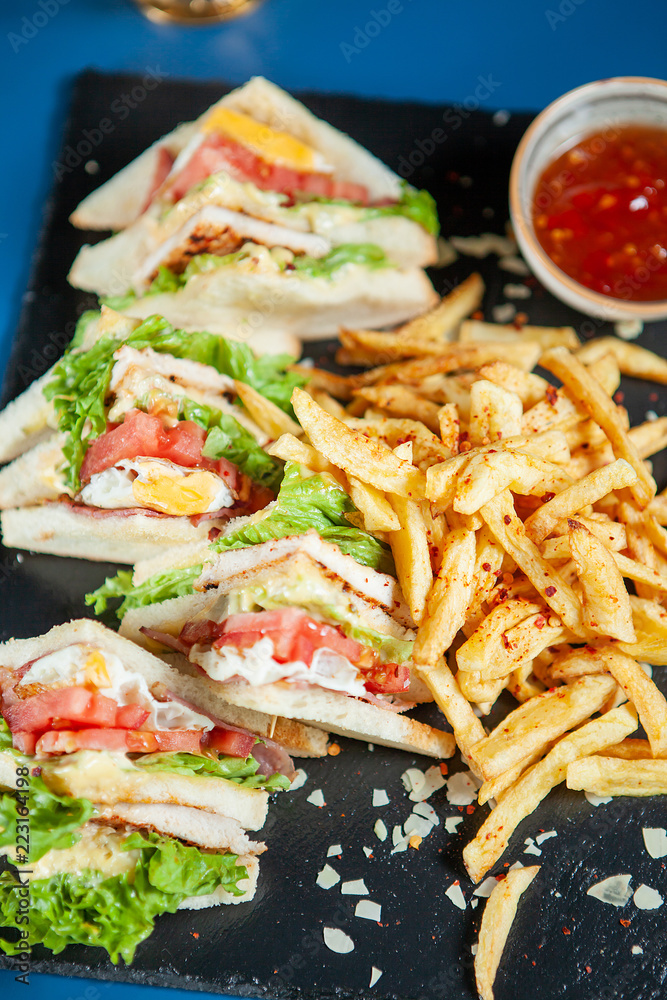 Delicious sandiwch with french fries and tasty red sos. Delicious sandiwch with french fries and tasty red sos.