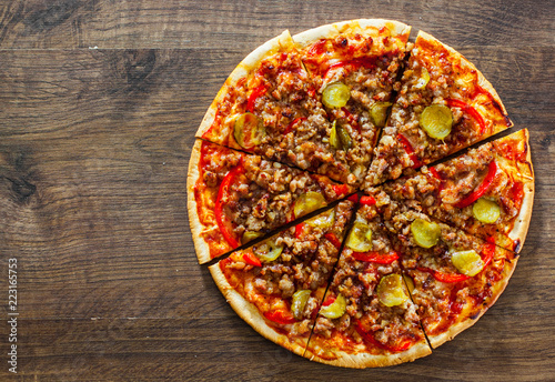 Pizza with Mozzarella cheese, minced meat and vegetables. Italian pizza on wooden background. with copy space. top view