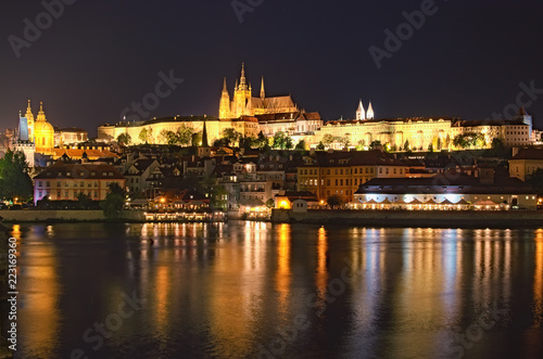 Summer night view of old Prague. Vltava river, Charles Bridge with illumination and Prague Castle with amazing Saint Vitus Cathedral. Prague, Czech Republic © evgenij84