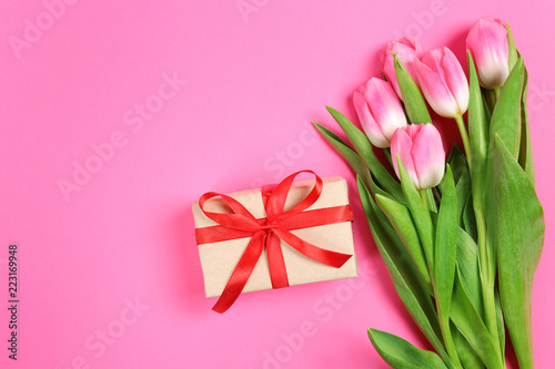 tulips and gifts on a pink background