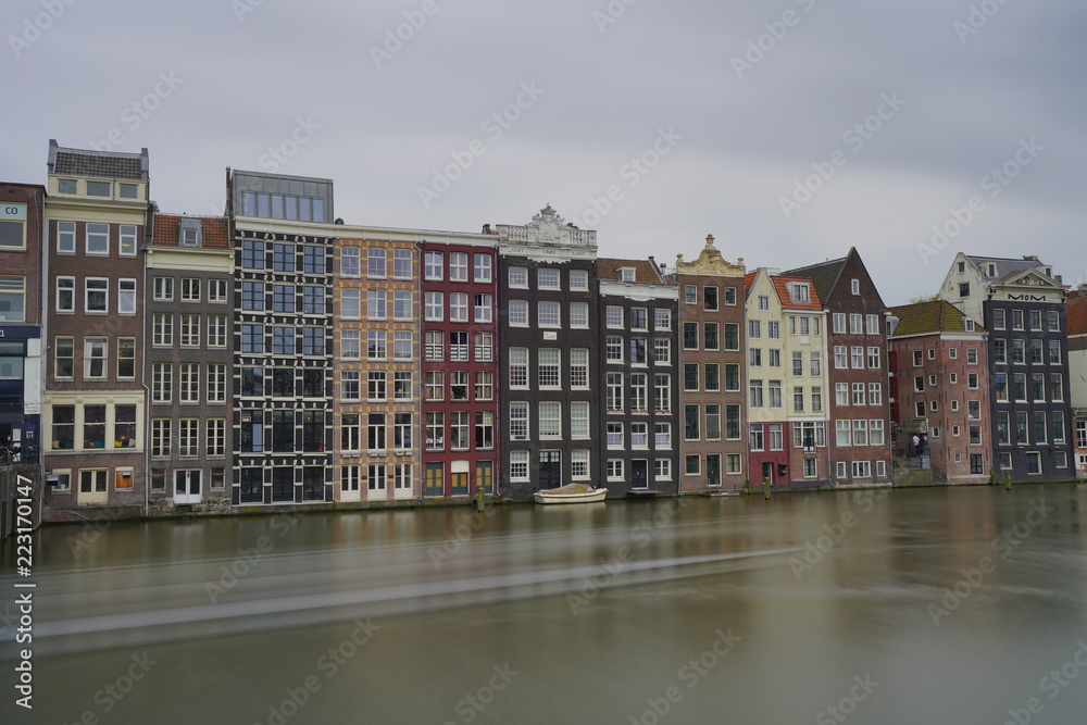a view of historic houses in front of rederij plas alongside amsterdam canals