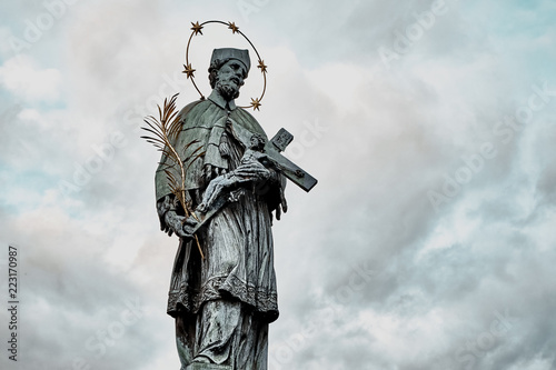 Statue of St. John of Nepomuk on the Charles bridge in Prague, Czech republic photo