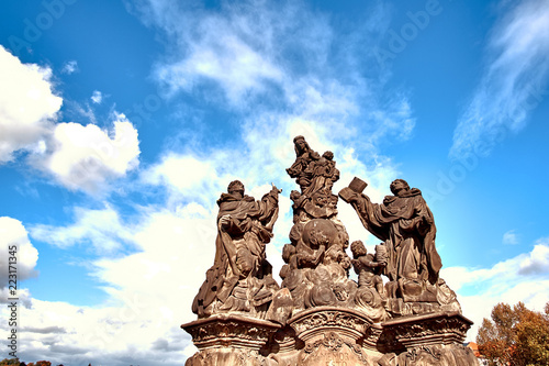 Virgin Mary statue at the Charles Bridge (Karluv Most) in Prague, Czech Republic. Close up view with blue sky