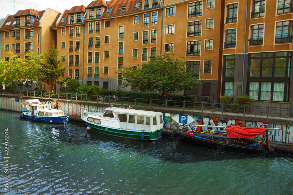 Beautiful elegant houses on the embankment, river, ships. City summer landscape. Berlin, river