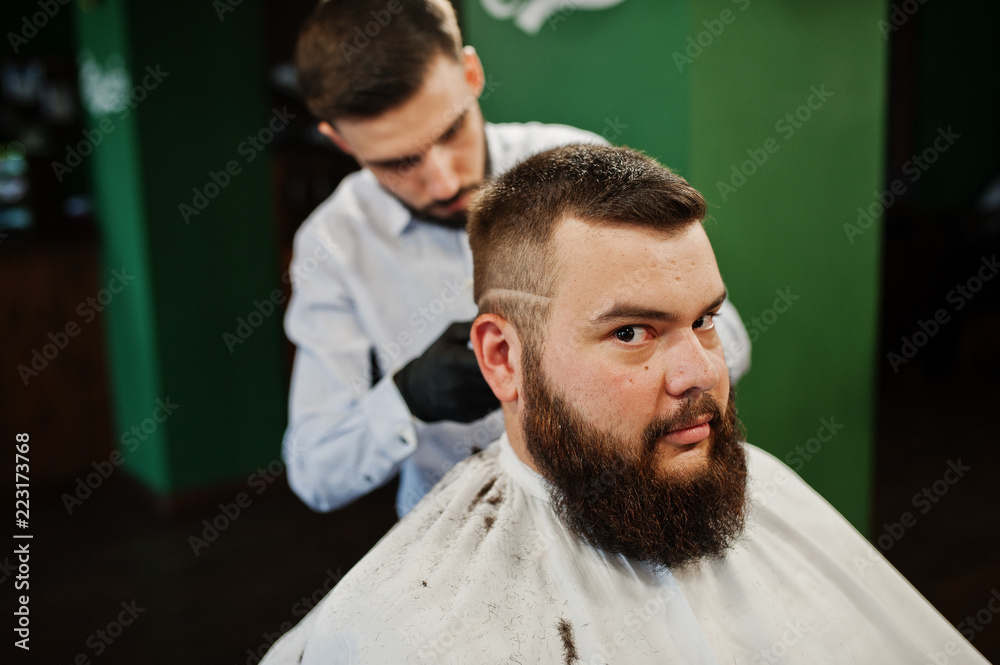 Handsome bearded man at the barbershop, barber at work. Handsome bearded man at the barbershop, barber at work.