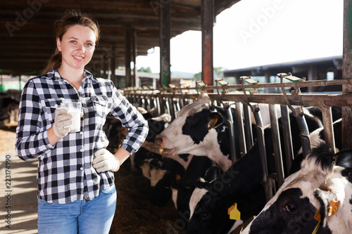 Woman with glass of milk on farm