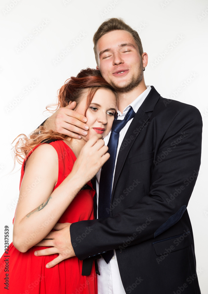 Joyful pregnant bride and groom standing together on a white background Joyful pregnant bride and groom standing together on a white background