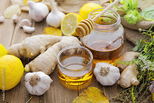 Honey, ginger, garlic, lemon and herbs. Alternative medicine photo