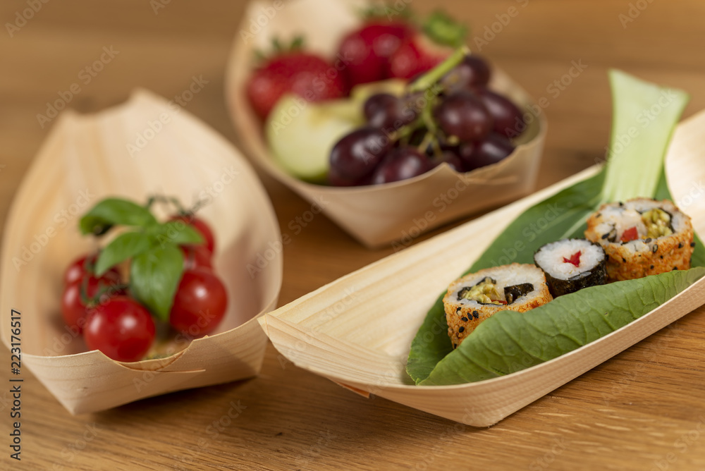 fresh healthy snack of sushi cherry tomatoes grapes and strawberries served on bamboo bowls fresh healthy snack of sushi cherry tomatoes grapes and strawberries served on bamboo bowls