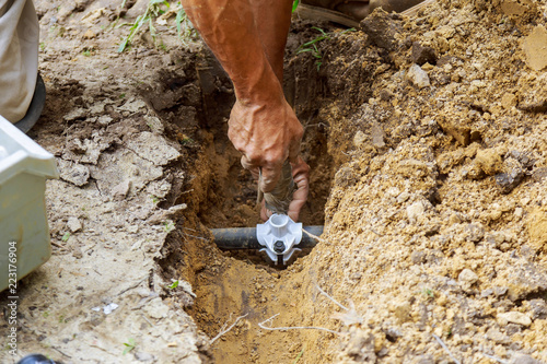 farmer installing irrigation system photo