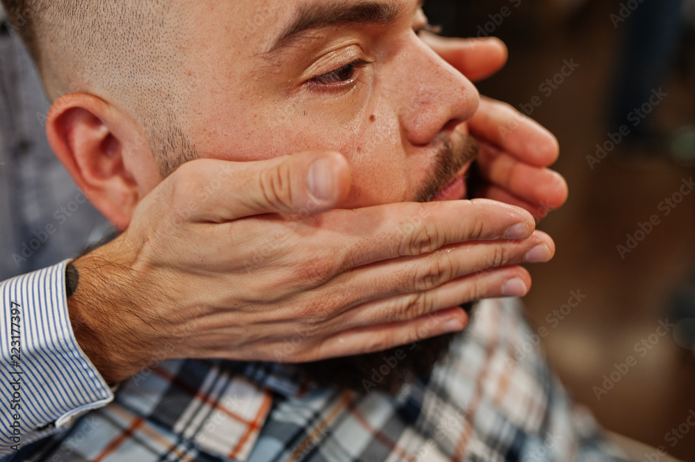Handsome bearded man at the barbershop, barber at work. Handsome bearded man at the barbershop, barber at work.