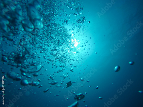 Air Bubbles Going to the Surface and Towards the Sun in a Blue Sea