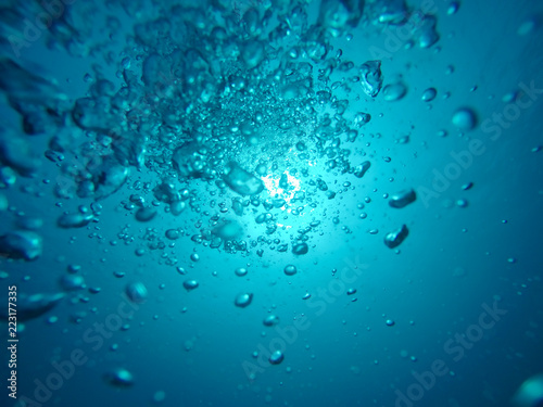Air Bubbles Going to the Surface and Towards the Sun in a Blue Sea