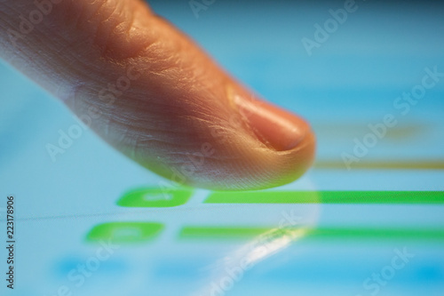 technology, business and people concept - close up of hand using computer touch screen