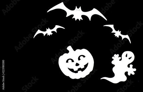 Close up white symbols of Halloween. Bats, pumpkin, ghost isolated on black background.