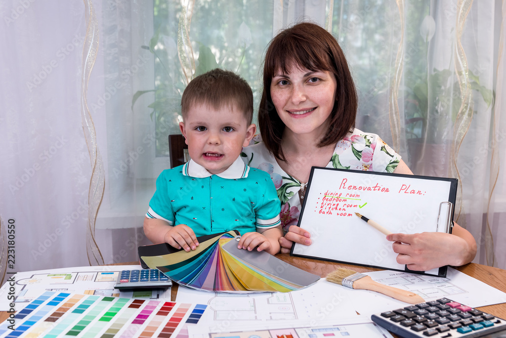 Happy couple mother and son with renovation plan Happy couple mother and son with renovation plan