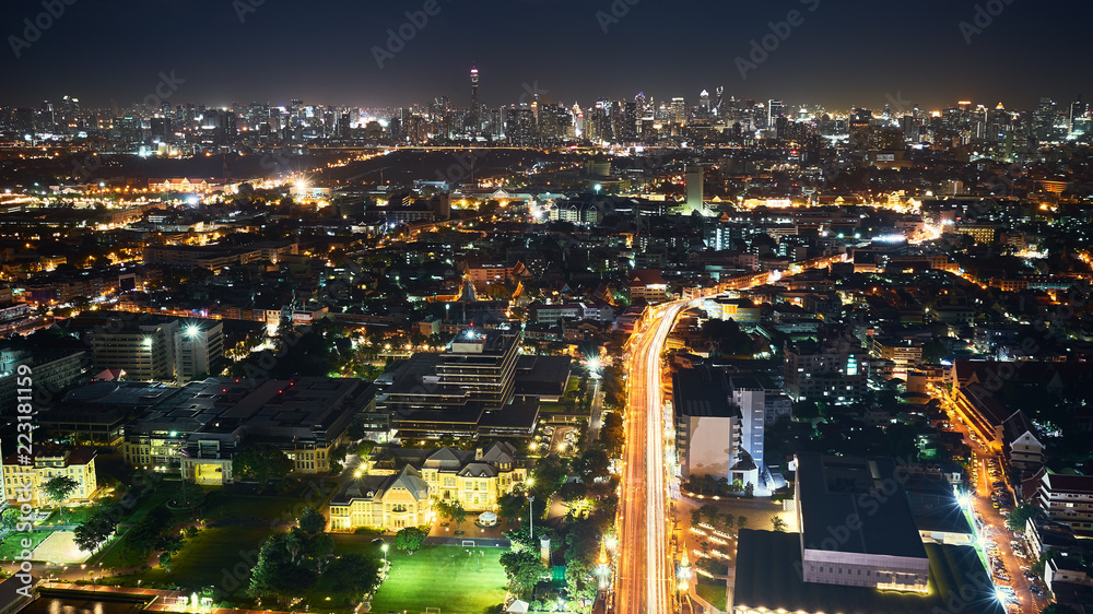 night aerial view of cityscape and light tail on bridge and road