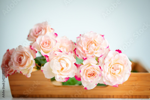 pink roses on a wooden tray