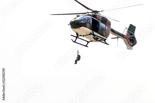 Rayong, Thailand - July 21 2018:the men lowered by a rope under a helicopter on the white background.