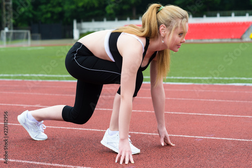 young athletic woman on treadmill outdoors