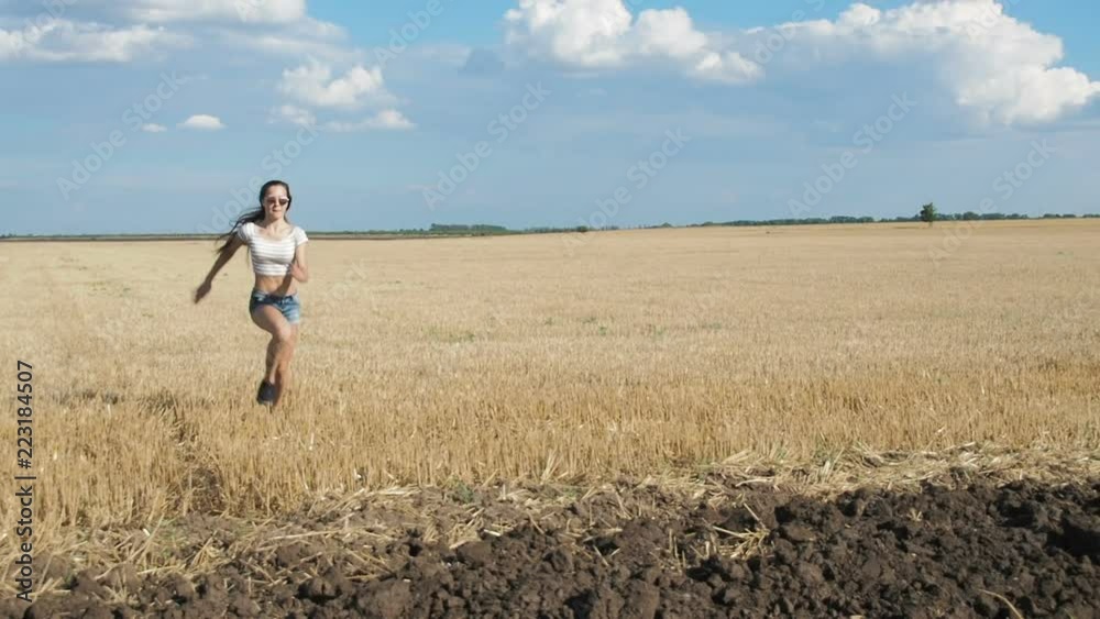 Beautiful girl jumping. Sporty girl running in the field. Beautiful girl jumping. Sporty girl running in the field.