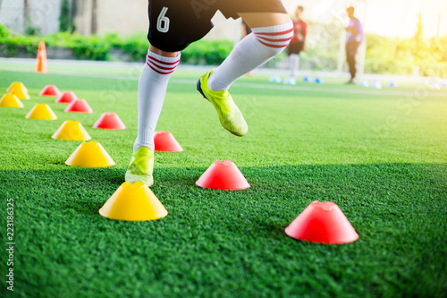 Kid soccer player moving speed test and Jogging and jump between marker