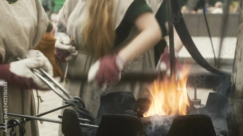 Female Blacksmiths Heating Iron photo