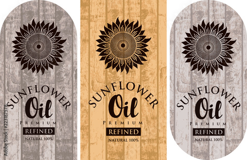 Set of three vector labels for refined sunflower oil with sunflowers and inscriptions on wooden background