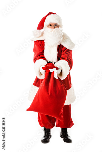 santa claus showing sack at camera isolated on white