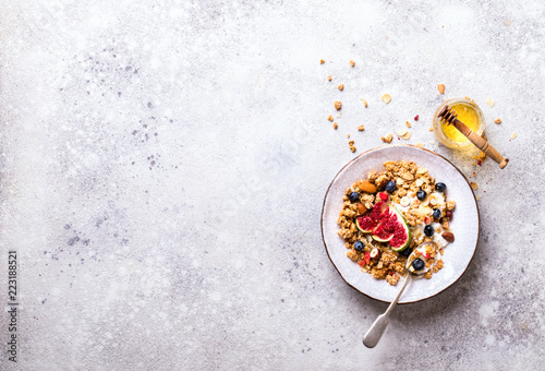 Muesli with Nuts Yogurt and fresh Figs Blueberry on the gray Background.Granola Healthy Breakfast. Sweet food Dessert. Snack Dry Diet Nutrition Concept.Top View. Flat Lay.Copy space for Text