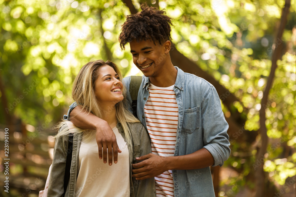 Cheerful young multiethnic couple spending time together Cheerful young multiethnic couple spending time together