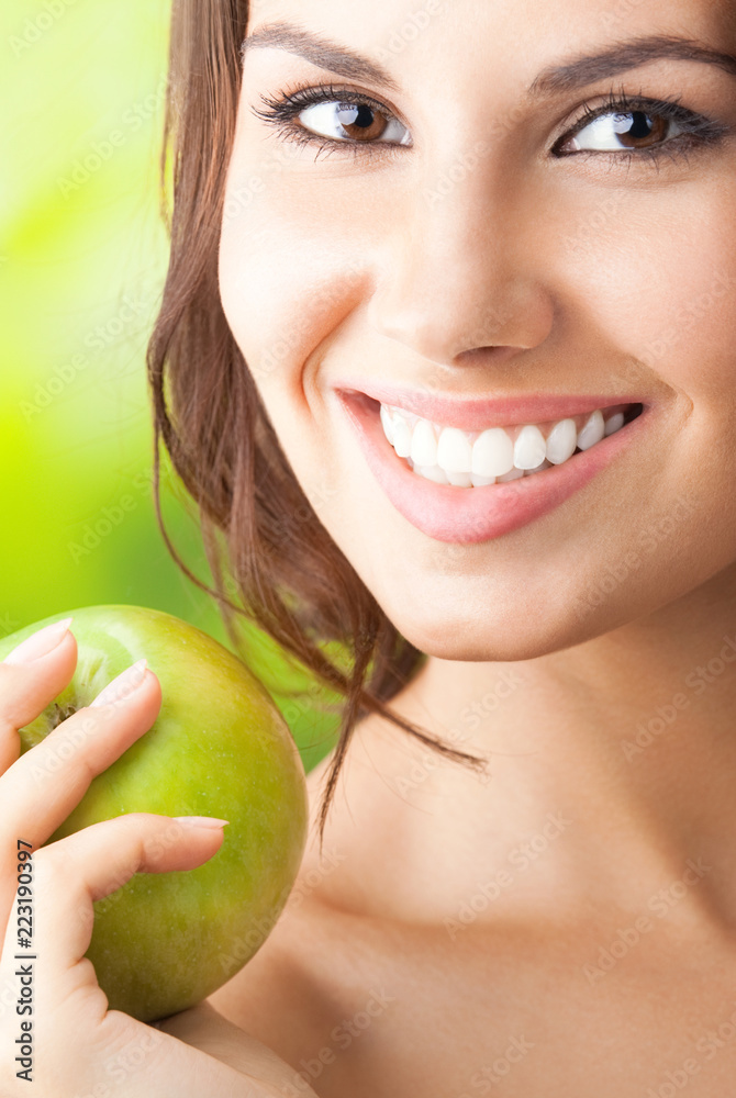 Young happy smiling woman with apple, outdoors Young happy smiling woman with apple, outdoors