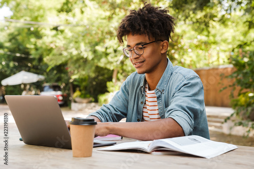 Smiling young african man student studying