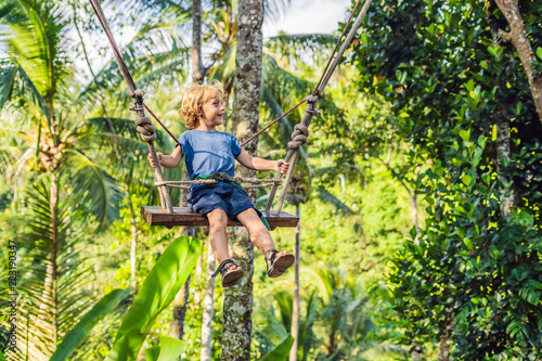 A boy on a swing over the jungle, Bali