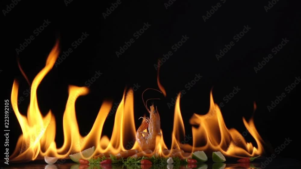 grill shrimp , barbecue sea food on fire flaming slow motion background. grill shrimp , barbecue sea food on fire flaming slow motion background.
