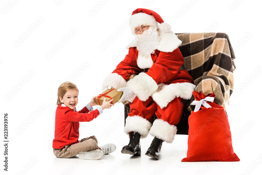 santa presenting christmas gift to excited little kid isolated on white santa presenting christmas gift to excited little kid isolated on white