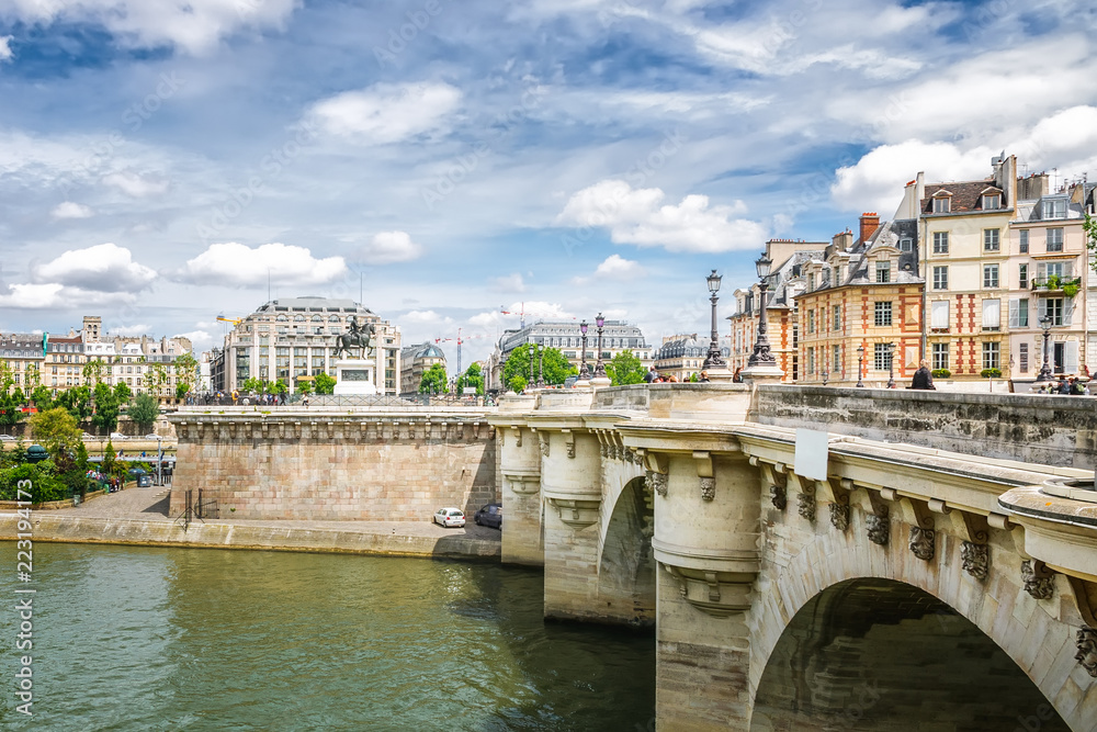 Naklejka premium Paris. The Pont Neuf and Place du Pont Neuf on a summer sunny day. View from left bank of the Seine river.