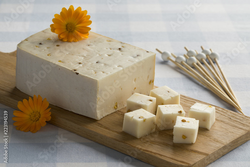 Goats cheese with coriander and fenugreek seeds photo