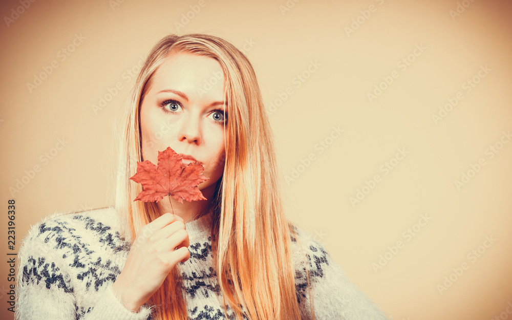 Woman holding orange autumn leaf Woman holding orange autumn leaf