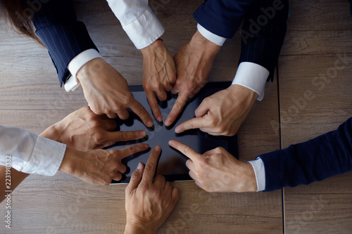 People hands in office clothes touching modern tablet in office. Business concept.