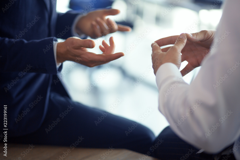 Close up of men hands making gestures while speaking in office. Business concept.