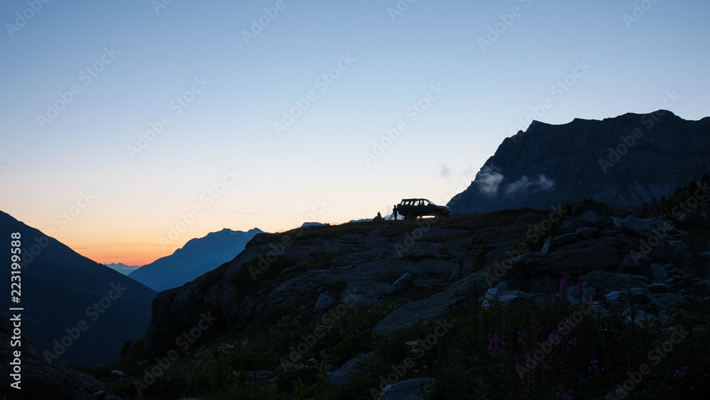 SUV 4x4 car on mountain top, scenic landscape at sunset, adventure exploration wanderlust on the Alps. SUV 4x4 car on mountain top, scenic landscape at sunset, adventure exploration wanderlust on the Alps.