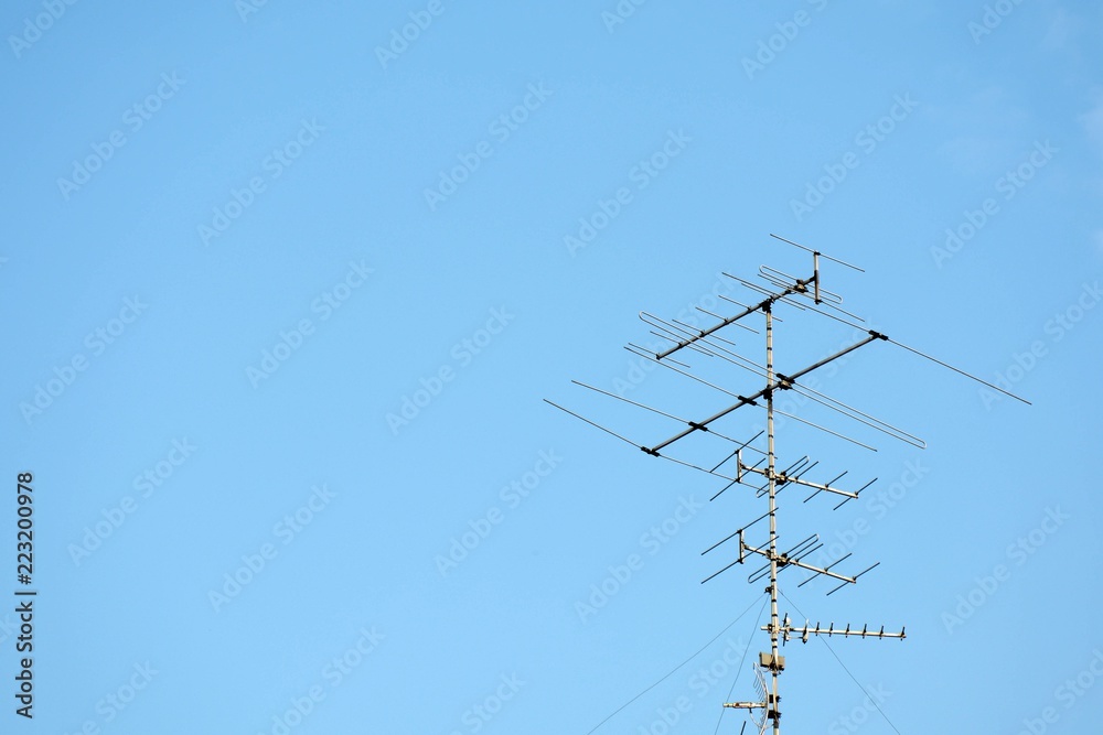 old televisions antenna on blue sky old televisions antenna on blue sky
